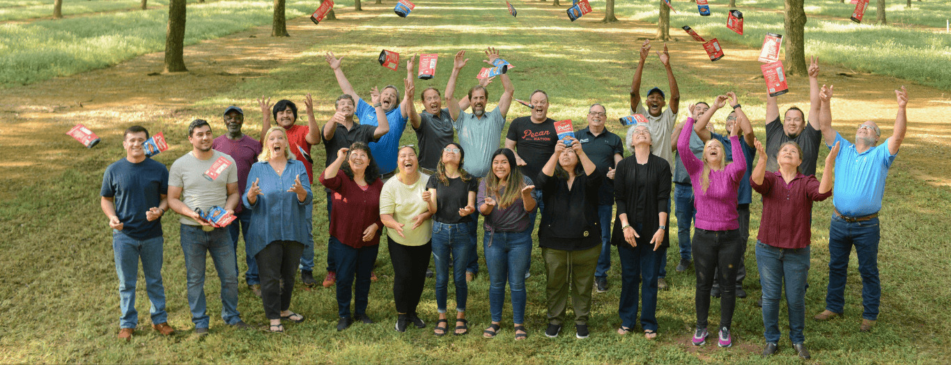 pecan nation team throwing pecan bags into the air