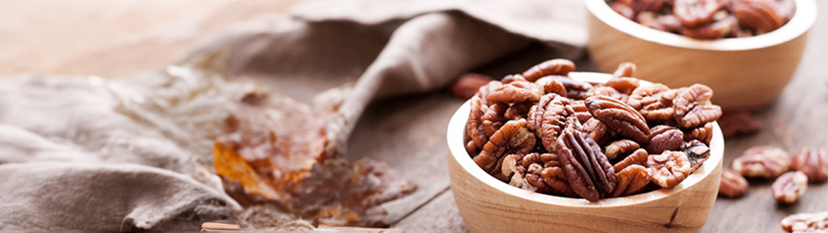 Two Wooden Bowls Overflowing with Pecans